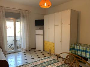 a small room with a bed and a refrigerator at Le Zagare apartments in SantʼAlessio Siculo