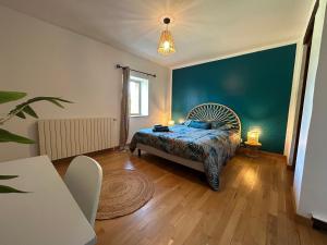 a bedroom with a bed and a blue wall at Espace cocooning 