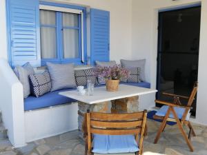 a porch with a blue couch and a table at Veranda to Aegean in Ligia