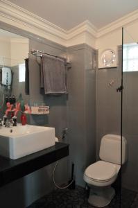 a bathroom with a white sink and a toilet at Villa b.Maison d'Hôtes Angkor in Siem Reap
