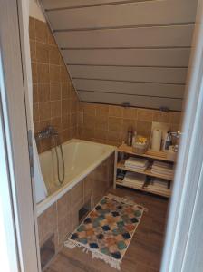 a bathroom with a bath tub and a rug at Kuća za odmor Iva in Lič