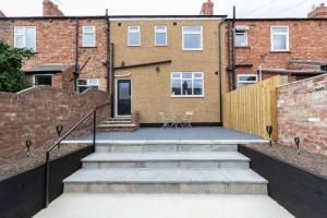 a brick building with stairs in front of a building at Stunning newly decorated House - TV in each Bedroom in Darlington