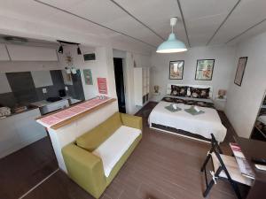 a small bedroom with a bed and a kitchen at Studio Apartments Fancy in Rijeka