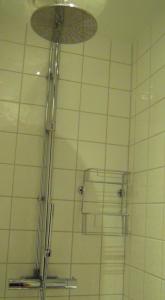 a shower in a bathroom with a shower head at Bed&Breakfast in nature 12 min from city free bikes in Stockholm