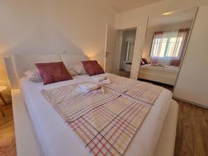 a bedroom with a large bed with towels on it at Apartments Manuel in Rab
