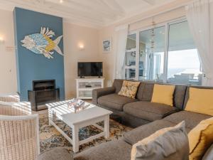 a living room with a couch and a table at Pinnacle Point Lodge 21 in Mossel Bay