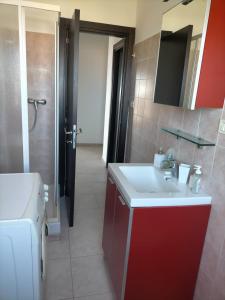 a bathroom with a sink and a washing machine at bellavista civico 100 in Pescara