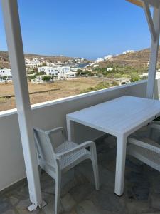 a white table and chairs on a balcony with a view at Gioia’s view in Loutrá