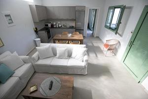 a living room with a white couch and a table at Pine House in Áyioi