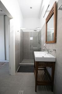 a bathroom with a sink and a shower at Pine House in Áyioi