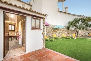 an open door to a yard with chairs and an umbrella at 4 bedrooms villa with city view private pool and furnished garden at Mondron in Mondrón