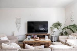 a living room with a flat screen tv on a wall at Bayview Towers 10 in Nelson Bay