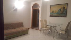 a room with a bed and a table and a couch at Solar Apartments in Herceg-Novi