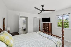 a bedroom with a bed and a ceiling fan at Lake Home, Dock, Fire Pit, Hot Tub, Game Room, Etc in Winchester
