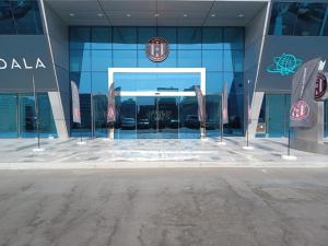 a building with a car reflection in the window at Al Jazira Club Hotel in Abu Dhabi