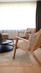 a wooden chair sitting in a living room at Lovely villa at the foot of the Funen Alps in Faaborg