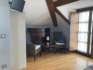 a living room with a dresser and chairs and a table at Casa Encarnacion in Santo Emiliano