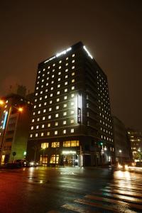 名古屋多美迎PREMIUM名古屋荣酒店的夜晚城市里灯火通明的建筑