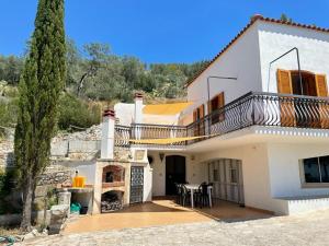 a villa with a balcony and a house at Colori del Sud - Residence in Mattinata