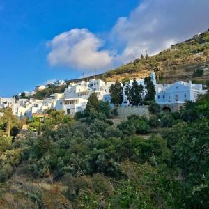 a group of white buildings on top of a hill at Aegean Garden Apartment in Kardhianí
