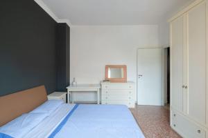 a bedroom with a bed and a desk and a tv at Nel cuore di Monteverde in Rome