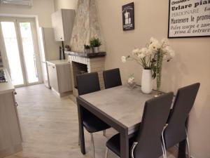 a kitchen and dining room with a table and chairs at La Torre in Tarquinia