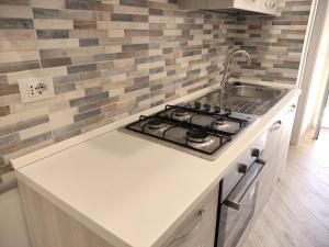 a kitchen with a stove and a sink at La Torre in Tarquinia