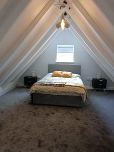 a bedroom with a bed in a attic at Raglans in Swindon