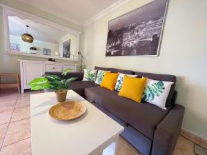 a living room with a couch and a table at Edificio Don Antonio in Los Cristianos