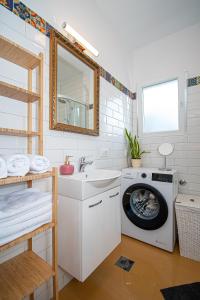 a bathroom with a washing machine and a sink at Apartment Nikola in Kastel Novi