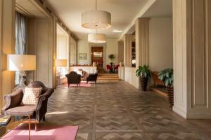 a hallway with chairs and a living room at Sina Villa Medici, Autograph Collection in Florence