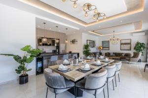 a dining room and living room with a table and chairs at Luxury Villa Diana with heated pool and jacuzzi in Dograde