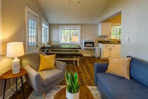 a living room with two chairs and a couch at Pet-Friendly Kalkaska Cottage on Lake Crawford! in Kalkaska
