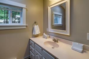 a bathroom with a sink and a mirror at Pet-Friendly Kalkaska Cottage on Lake Crawford! in Kalkaska +16 photos