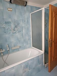 a bath tub in a bathroom with a shower at Appartemento Casa Giuli in Passo del Tonale