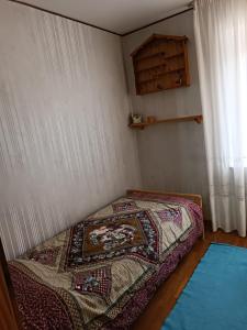 a bedroom with a bed with a rug on the floor at Appartemento Casa Giuli in Passo del Tonale