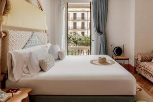a bedroom with a large white bed with a window at Montesol Experimental Ibiza in Ibiza Town
