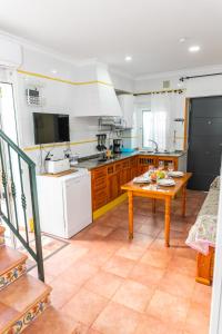 a kitchen with a table in the middle of it at Casa Marinero - Patio Andaluz in Barbate