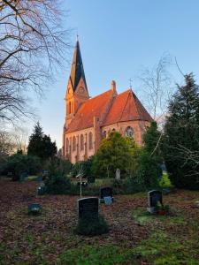 eine Kirche mit rotem Dach und einem Turm in der Unterkunft Casa53N in Seevetal