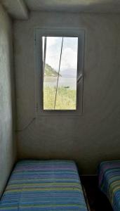 a small room with a window and a bed at Apartment Lake Oasis ''Oko'' in Krnjice +25 photos