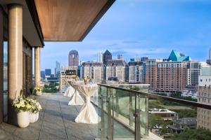 a balcony with a table and chairs on it at Marriott Dallas Uptown in Dallas