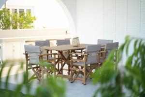 a wooden table and chairs on a patio at Meneou Houses by the Sea in Larnaka