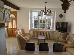 a living room with two chairs and a tv at Gites De La Melautais in Saint-Juvat