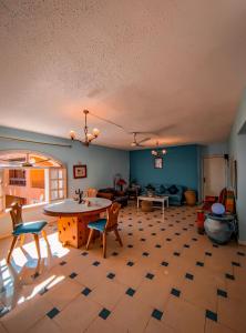 a large living room with a table and chairs at Villa sarda Blue in Dahab