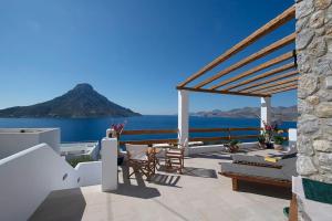 a patio with a view of the ocean and a mountain at Villa Kalydna in Kalymnos