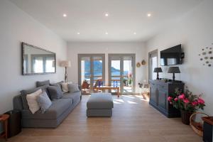 a living room with a couch and a table at Villa Kalydna in Kalymnos