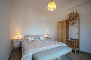 a bedroom with a bed and two tables and two lamps at Villa Kalydna in Kalymnos +19 photos