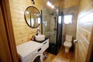 a bathroom with a sink and a washing machine at Domek Całoroczny Powidz tel 512-589-997 in Powidz