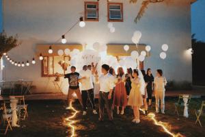 un gruppo di persone in piedi in un cortile con dei palloncini di 峨眉山一方民宿Mount Emei Little Place Guesthous a Monte Emei (Emeishan) Altre 37 foto