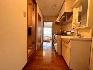 a kitchen with a sink and a counter top at 東横のヨコ in Okayama
